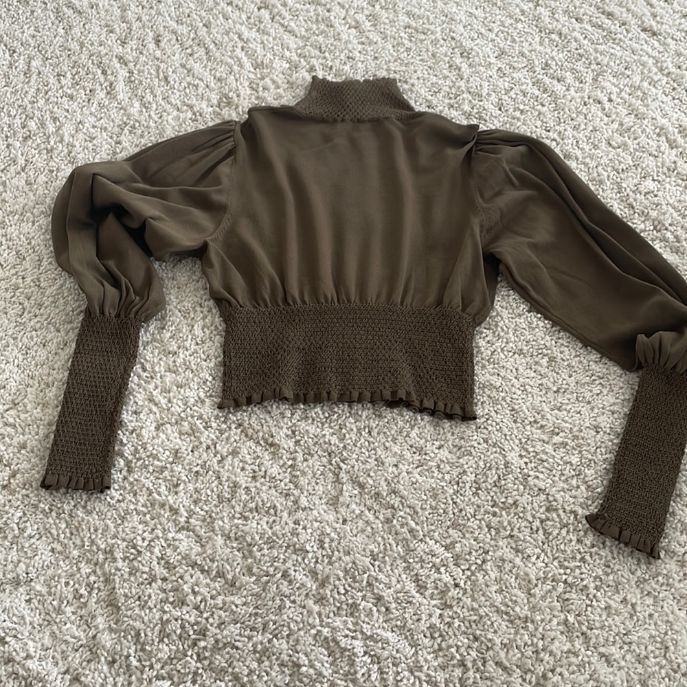 Zara olive turtleneck with detailing in the arms,  waist band and neck.